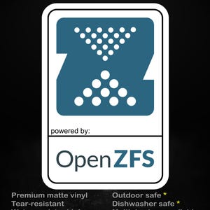 May include: A rectangular sticker with a white border on a black background. The top features a blue Z-shaped icon with white dots. Below, the text reads: stick me! somewhere cool... powered by: OpenZFS. Bottom text lists features: Premium matte vinyl, Tear-resistant, Water-resistant ink, Outdoor safe, Dishwasher safe, Multiple sizes available.