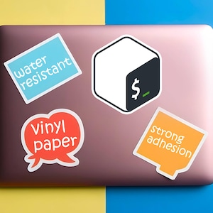May include: A collection of stickers on a laptop. The stickers include text that reads "water resistant", "vinyl paper", and "strong adhesion". One sticker features a white cube with a black corner and a dollar sign.