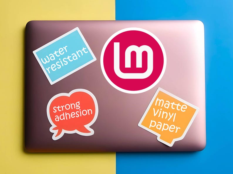 May include: A collection of stickers on a laptop. The stickers include a blue rectangle with "water resistant", a red circle with a white "lm" logo, an orange speech bubble with "strong adhesion", and an orange square with "matte Vinyl paper".
