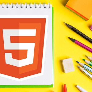 May include: A spiral-bound notepad displays a large orange and white HTML5 logo. The notepad is surrounded by pencils, an eraser, and a pencil sharpener on a bright yellow surface. The pencils are black, purple, green, and silver.