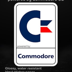 May include: A white rectangular sticker featuring the Commodore logo in blue and red. The text "powered by Commodore OS" is at the top. The sticker also says "powered by: Commodore". It is glossy, water resistant vinyl sticker paper, available in different sizes.