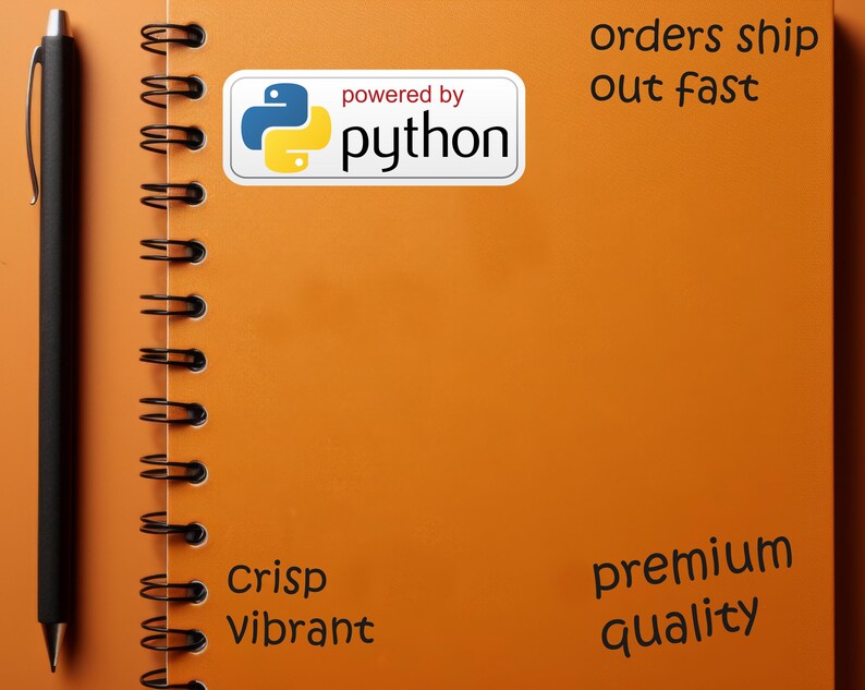 May include: An orange spiral notebook with a black pen on the left side. A white sticker with the text "powered by python" is on the notebook. The notebook also has the words "Crisp Vibrant" and "premium quality".