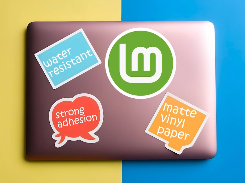 May include: A collection of stickers on a laptop. The stickers include a green circle with a white "Lm" logo, a blue rectangle with "water resistant", a red speech bubble with "strong adhesion", and an orange square with "matte Vinyl paper".