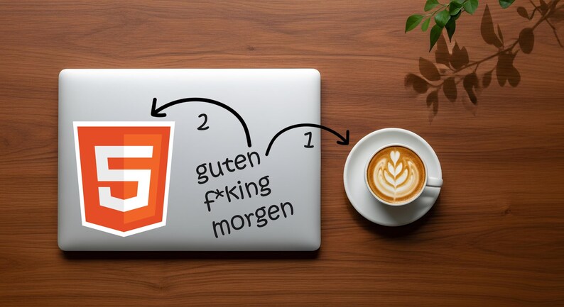 May include: A laptop with a sticker of the HTML5 logo and the text "guten f*king morgen". A cup of coffee with latte art sits to the right. The items are on a wooden surface.