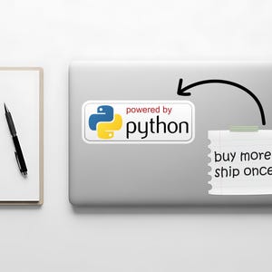 May include: A laptop with a sticker that says "powered by python" in white text with a blue and yellow logo. A sticky note with the text "buy more, ship once" is attached to the laptop. A pen and notepad are on the left.