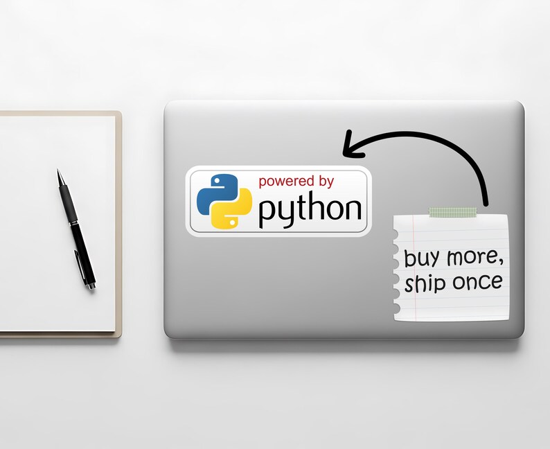 May include: A laptop with a sticker that says "powered by python" in white text with a blue and yellow logo. A sticky note with the text "buy more, ship once" is attached to the laptop. A pen and notepad are on the left.