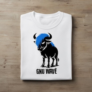 May include: White t-shirt featuring a black bull illustration with blue hair and the text "GNU WAVE" in black. The bull has horns and is standing on a black base. The shirt is folded on a wooden surface.