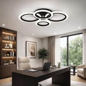 May include: Modern ceiling light fixture with a black frame and five white LED rings. The light is installed in a home office with a dark wood desk, a beige chair, and a large window with a view of trees.