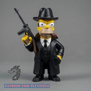 May include: A yellow-skinned character figurine dressed in a black suit, white shirt, black tie, and black fedora hat. The figure holds a black submachine gun in one hand and has a brown cigar in its mouth. Text at the bottom reads PATREON.COM/FLEXICREA.
