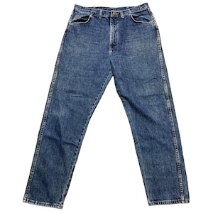 May include: Blue denim jeans with a classic five-pocket design. The jeans have a straight leg cut and a button and zipper closure. The denim has a faded, worn look.