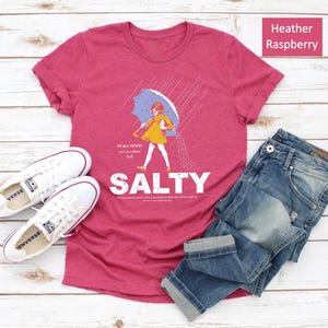 Bring summer sass to your wardrobe with the Salty Girl T-Shirt! 💕 A cozy, vintage-washed tee for women who love sunshine and statement style. Pair it with denim shorts or leggings — perfect gift for friends who live for beach vibes!