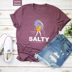 Make waves with the Salty Girl Tee! 🌊 This women’s vintage cotton blend shirt adds a sassy touch to your summer look. Comfortable, lightweight, and effortlessly trendy — great for travel, casual days, or as a fun beach gift for your girls!
