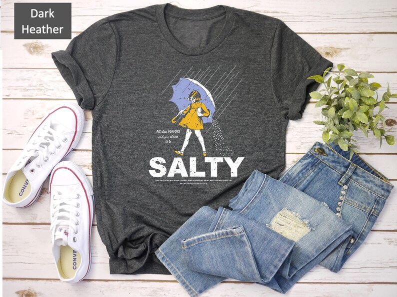 Add coastal charm to your outfit with this Salty Girl Graphic Tee. 🌴 A retro summer t-shirt designed for women who love the ocean breeze. Soft cotton blend, relaxed fit, and faded vintage style. Ideal gift for her or beach vacation outfit!