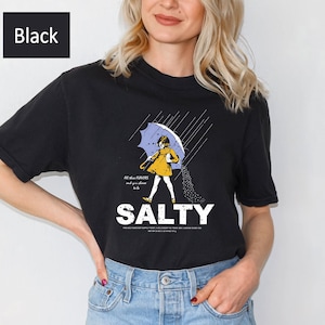 Show your attitude with our Salty Girl Shirt! 🌞 Crafted from a breathable vintage cotton blend, this women’s graphic tee is perfect for beach days or casual hangouts. Trendy summer style with a sassy edge — a fun gift idea for your bestie or sister!