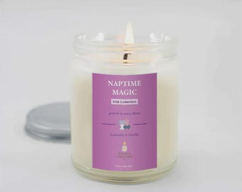 May include: A lit candle in a clear glass jar with a purple label. The label reads "NAPTIME MAGIC Kids Collection" with the scent "Lavender & Vanilla". The candle is 255 g.