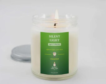 May include: A lit, unscented candle in a clear glass jar with a silver lid. The candle has a green label that reads "SILENT LIGHT Lights Collection" and "different lights, same shine." The jar is 7.6 cm wide and contains 255 g of wax.