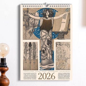 May include: A 2026 wall calendar featuring a central illustration of a figure with outstretched arms against a blue moon, surrounded by intricate line art panels. The calendar includes the year 2026 and various names printed in black text at the bottom.