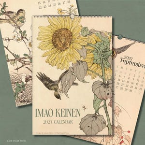 May include: A 2027 wall calendar titled IMAO KEINEN featuring a large yellow sunflower illustration with green leaves and a small bird in flight. The cream-coloured paper has a vintage aesthetic with detailed botanical and avian line art.