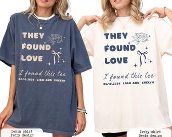 May include: Two t-shirts, one denim blue and one ivory, each with the text "THEY FOUND LOVE" and "I found this tee" along with a date and names. The design includes an angel and a bow.
