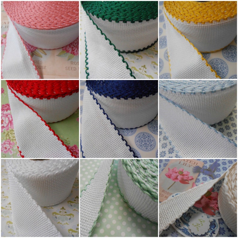 May include: A close-up of ten spools of white cotton trim with different colored edges. The colors include red, green, yellow, blue, light blue, and green. The trim is perfect for adding a touch of color and texture to any project.