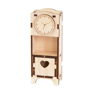 May include: A wooden clock with a heart-shaped cutout on the front. The clock has a simple face with black hands and a brown frame.