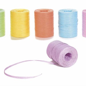May include: A collection of colorful raffia ribbon spools in shades of green, yellow, orange, blue, and pink. One spool is unraveled, showing the ribbon's texture. Ideal for crafting and gift wrapping.