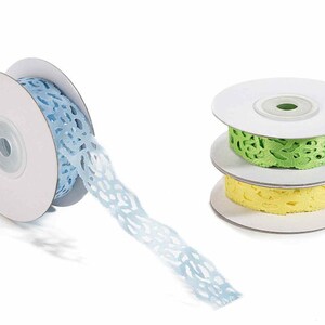 May include: Three spools of lace ribbon, one light blue, one light green, and one yellow. The ribbon is on white cardboard spools.