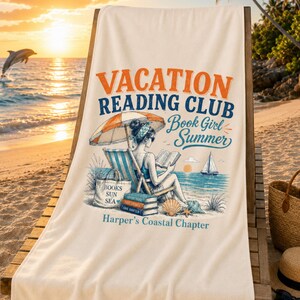 May include: A cream-colored beach towel featuring the text VACATION READING CLUB, Book Girl Summer, and Harper's Coastal Chapter. The graphic depicts a person sitting in a striped beach chair under an umbrella reading a book by the ocean.