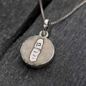 Ben Porat Yosef on semi-raw Jerusalem stone silver necklace against evil eye