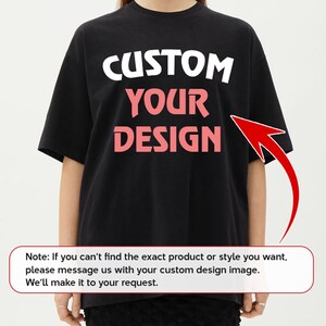 A person wearing a black t-shirt with the text "CUSTOM YOUR DESIGN" printed on it.