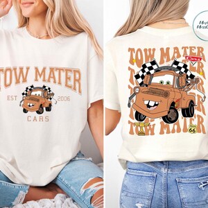 The image is a collage of two photos featuring a white t-shirt with a cartoon tow truck design and text.