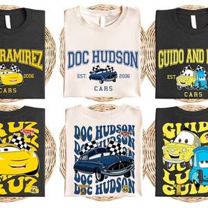 six t-shirts, each featuring a different cartoon character from the Cars movie franchise. The characters include Cruz Ramirez, Doc Hudson, Guido and Luigi, and other well-known characters from the animated series.