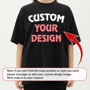 A person wearing a black t-shirt with the text "CUSTOM YOUR DESIGN" printed on it.