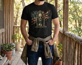 May include: Black crew neck t-shirt featuring a graphic of a skeletal figure with an American flag background. The design is detailed and patriotic. The person is wearing blue jeans and a brown jacket.