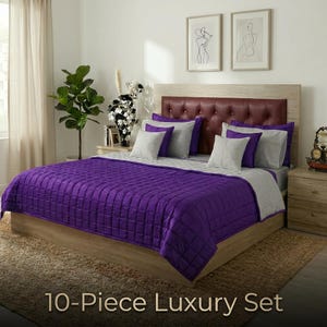 May include: A luxurious 10-piece bed set featuring a quilted purple comforter and matching pillows. The bed has a wooden frame and a burgundy headboard. The set is displayed in a well-lit bedroom setting.