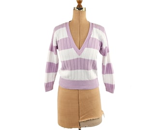 May include: A lilac and white striped V-neck sweater displayed on a mannequin. The sweater has long sleeves and a ribbed texture. The background is plain white.