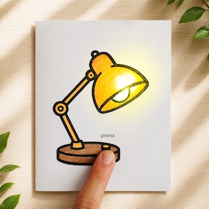 May include: A whimsical illustration of a desk lamp with a glowing yellow lampshade. The lamp is brown and yellow, with the word "press" below a button. A finger is pressing the button, suggesting activation.