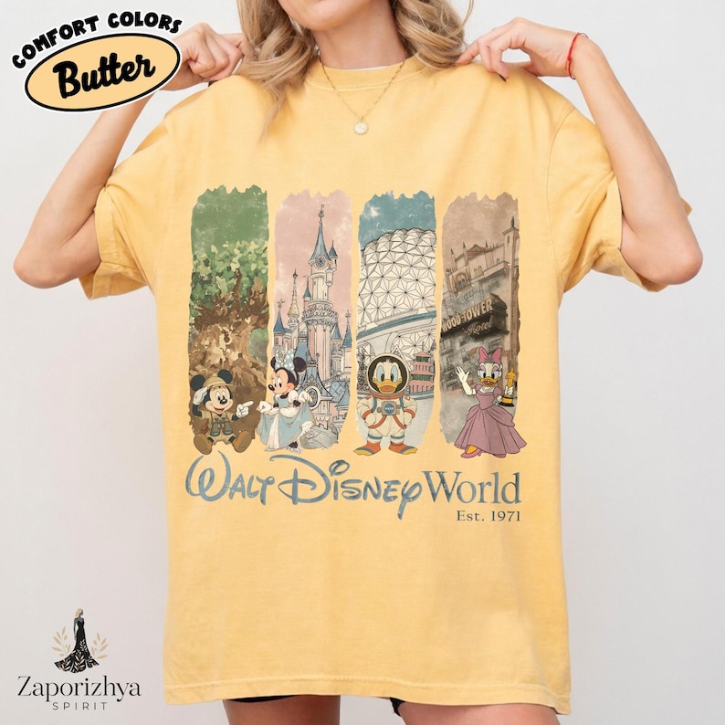 May include: Yellow t-shirt with a graphic featuring Mickey Mouse, Minnie Mouse, Donald Duck, and Daisy Duck, and the text "Walt Disney World Est. 1971." The shirt has the words "Comfort Colors Butter" printed on it.