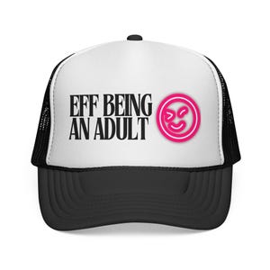May include: A black and white trucker hat with the text "EFF BEING AN ADULT" in black, and a pink smiley face logo. The hat has a black brim and mesh back, and a white front panel.