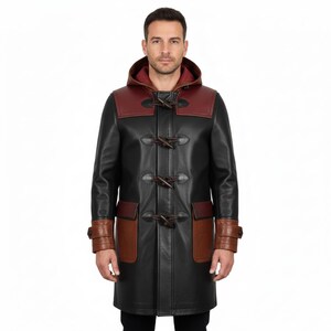 May include: A black leather duffle coat with a burgundy hood and shoulder yoke. The coat features brown leather accents on the pockets and cuffs, and wooden toggle closures. The coat is knee-length.
