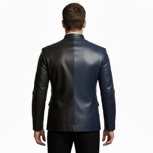 May include: A two-tone leather blazer, split vertically with one side black and the other navy blue. The jacket has a classic tailored fit with a notched lapel and two front pockets. The model is wearing black pants.