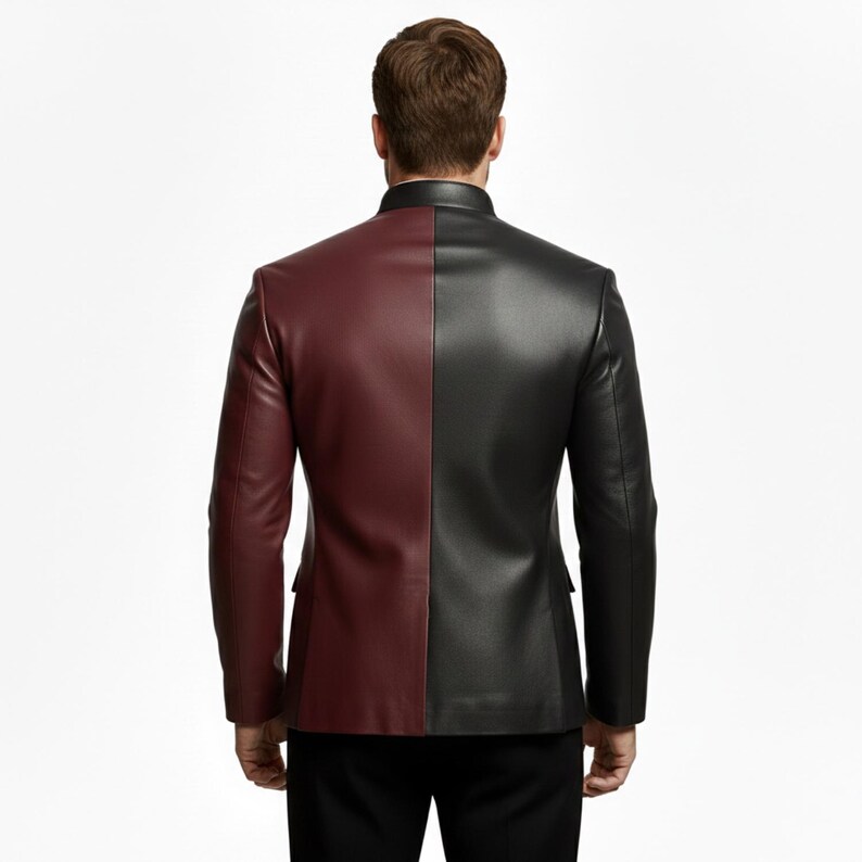 May include: A two-tone leather jacket, with a burgundy left side and a black right side. The jacket has a mandarin collar and two side pockets. The back view shows the jacket's tailored fit.