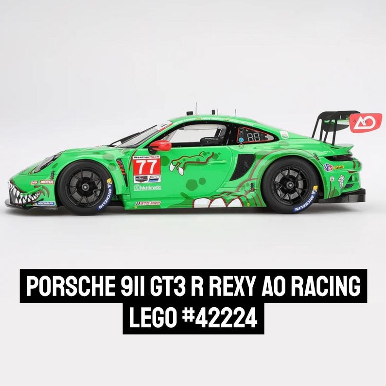 May include: A green Porsche 911 GT3 R race car with a dinosaur-themed design. The car features the number 77 and the text "REXY AO RACING". The model is a LEGO set, #42224, with black wheels and a rear spoiler.