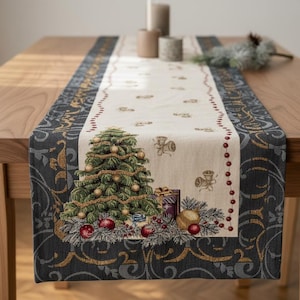 May include: Christmas-themed table runner featuring a decorated Christmas tree, gifts, and ornaments. The runner has a cream-colored center with a dark gray and gold patterned border. Candles and a pinecone are on the wooden table.