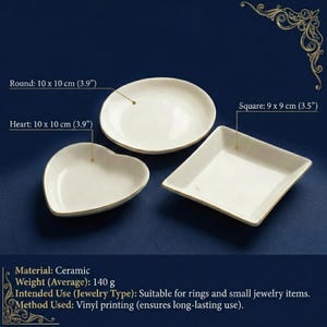 May include: Three ceramic jewelry dishes in heart, round, and square shapes. The heart and round dishes are 3.9 inches across, and the square dish is 3.5 inches across. The dishes are white with gold trim and are suitable for rings and small jewelry items.