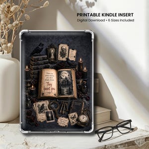 May include: A rectangular Kindle insert featuring a dark, gothic illustration of an open book with the text 'There are some stories you don't simply finish. They haunt you.' surrounded by candles, keys, a pocket watch, and raven imagery.