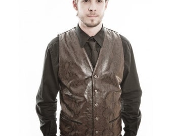 May include: A brown faux leather waistcoat with a snakeskin pattern. The waistcoat has a button fastening and a black shirt underneath.