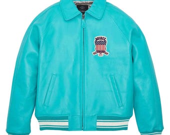 May include: A turquoise leather jacket with a zip-up front, collar, and ribbed cuffs and hem. The jacket features a patch with the text "AVIREX" and an American flag design. The jacket has two front pockets.