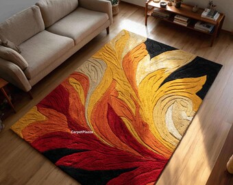 May include: A rectangular area rug with a floral design in shades of red, orange, yellow, and beige against a black background. The rug is placed on a hardwood floor, with a beige sofa visible in the background. The text "CarpetPlazza" is visible.