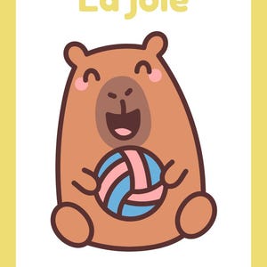 May include: A cartoon illustration of a smiling brown bear holding a blue and pink ball. The bear has pink cheeks and is set against a white background with the French text "La joie" at the top, all within a yellow border.